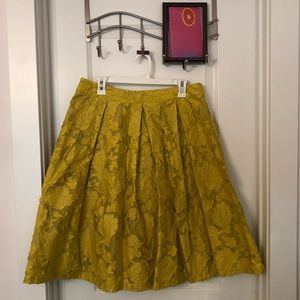 Knee length bright mustard skirt.